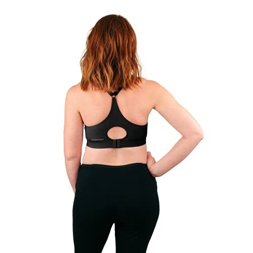 Person wearing a black sports bra from the back.