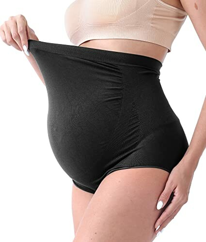 Pregnant woman wearing high-waisted black maternity shapewear.