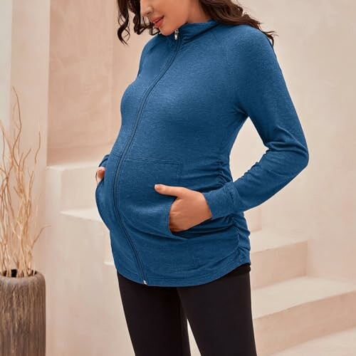 Pregnant woman wearing a blue maternity hoodie