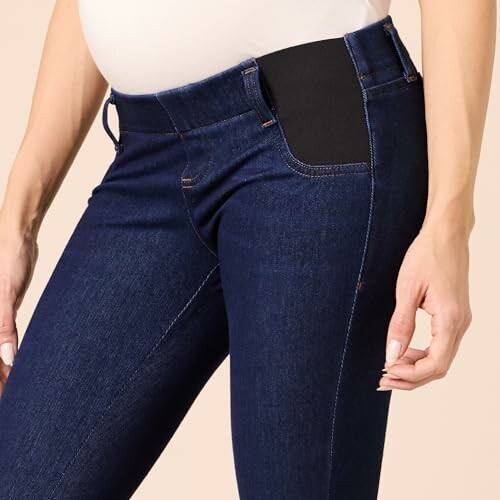 Close-up of maternity jeans with elastic waistband.