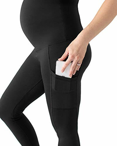 Pregnant woman wearing black leggings with a pocket holding a phone.