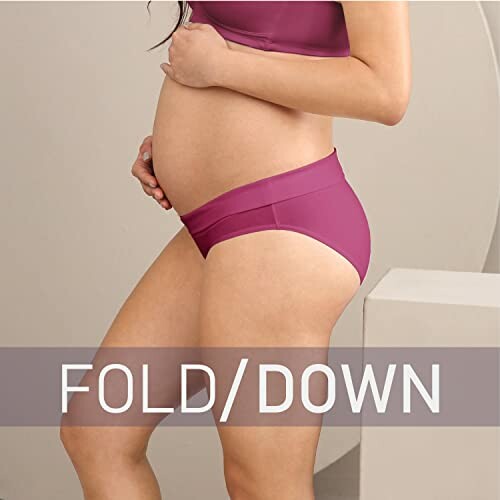 Pregnant woman wearing fold-down maternity underwear.