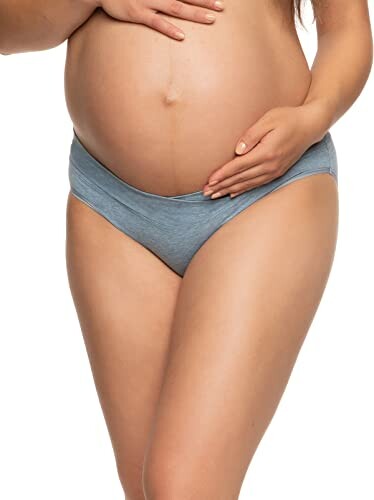 Pregnant woman wearing blue maternity underwear.